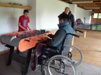 A wheelchair user playing table football
