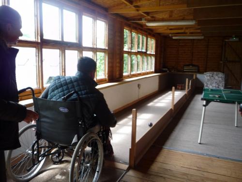 A wheelchair user playing skittles